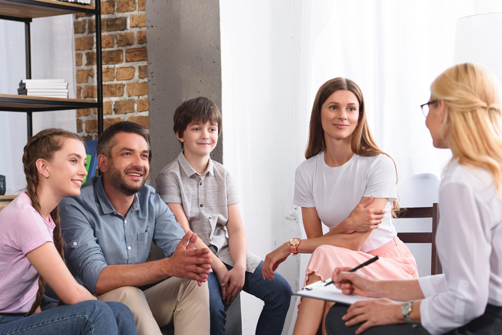 happy family sitting on therapy session by female 2021 08 29 22 51 23 utc min scaled